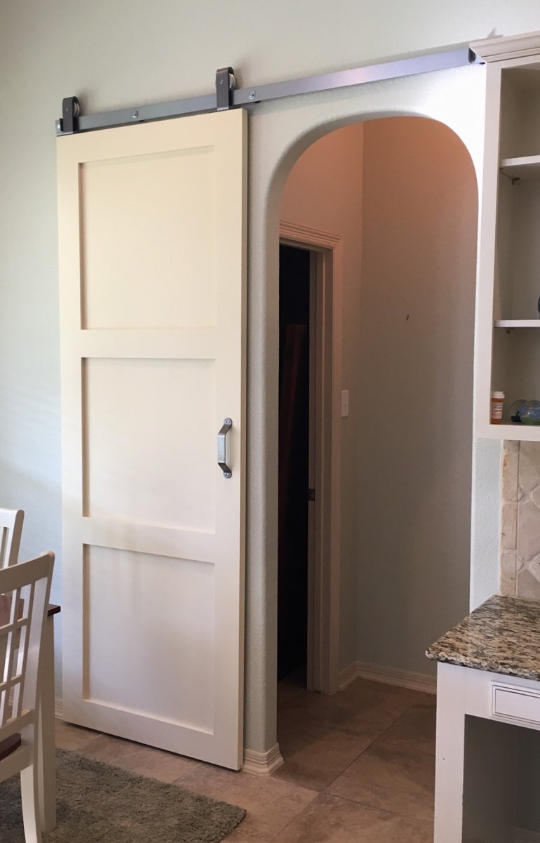 Quaker style barn door in San Antonio kitchen.